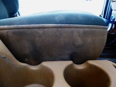 two brown bowls sitting next to each other on top of a table in front of a blue chair