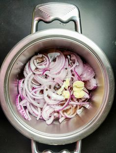 onions are being cooked in a pot on the stove