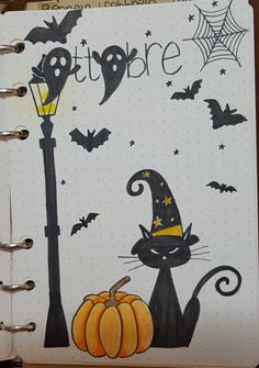 an open notebook with halloween drawings on it