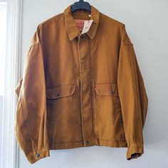 Super Cool Looking Levi's Canvas Trucker Jacket, Oversized Look, Very Sturdy, Will Last For Years. I Bought Two Am Keeping One. New W/ Tags. I Absolutely Love This Jacket For Layering Or With Just A T Shirt. Pockets Are Deep And Warm. Tag Says 2xl But These Were Purposely Designed Oversized So More Like A 3xl. Check Measurments In Photos. Here Is More Info From Levi's: Dubbed The Rancher Trucker For Its Durability And No-Fuss Style, This Jacket Was Made For The Long Haul. You'll Love Its Sturdy Levi's Long Sleeve Utility Outerwear, Levi's Oversized Outerwear For Streetwear, Vintage Oversized Outerwear With Pockets, Levi's Button-up Outerwear For Streetwear, Levi's Button-up Streetwear Outerwear, Levi's Button-up Fall Outerwear, Levi's Long Sleeve Outerwear With Pockets, Levi's Long Sleeve Utility Jacket For Fall, Levi's Brown Outerwear For Spring