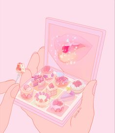 a person holding a pink box filled with cakes and cupcakes