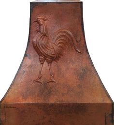 a copper colored oven hood with a rooster on it