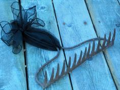 a piece of metal sitting on top of a wooden floor next to a hair comb