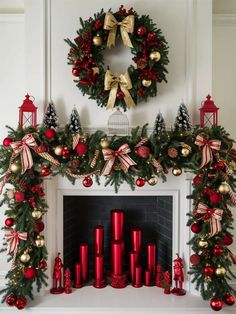 a fireplace decorated for christmas with red candles and wreaths on the mantle next to it