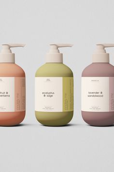 three different types of hand soaps on a gray background, one is green and the other is pink