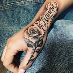 a person with a rose tattoo on their hand