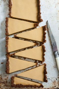 there are several pieces of pie on the table with a knife next to it and one slice missing