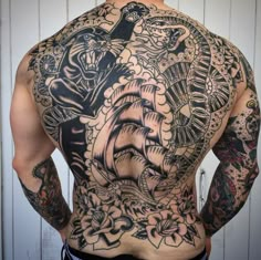 the back of a man with tattoos on his body