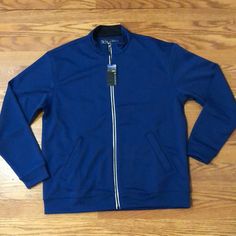 This Is A Full Zip Pebble Beach Track Jacket. It Is Not Lined And Has A Smooth Polyester Feel. It Is Size Medium Navy Casual Track Jacket With Pockets, Navy Long Sleeve Track Jacket For Spring, Casual Blue Track Jacket For Fall, Blue Track Jacket With Pockets For Fall, Blue Long Sleeve Track Jacket For Spring, Casual Blue Outdoor Outerwear, Casual Blue Outerwear For Outdoor, Blue Long Sleeve Track Jacket For Outdoor, Casual Blue Track Jacket For Winter