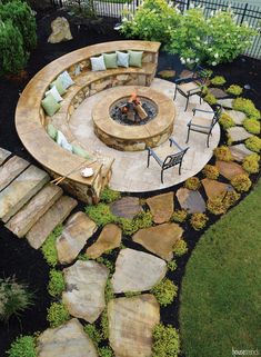 an outdoor fire pit with seating around it