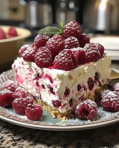 a dessert with raspberries and whipped cream on a plate