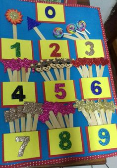 a table topped with lots of cupcakes and numbers