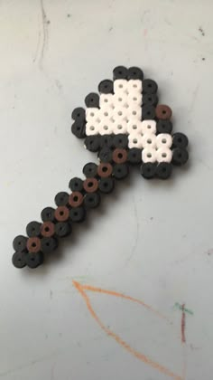 a piece of black and white beaded brooch sitting on top of a table