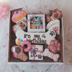 a box filled with lots of decorated cookies