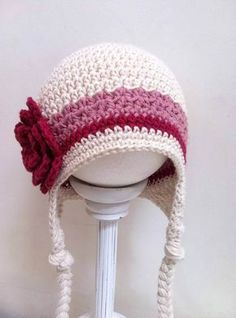 a crocheted hat with a flower on top