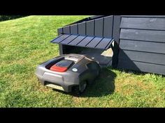 a lawn mower sitting in the grass next to a bench