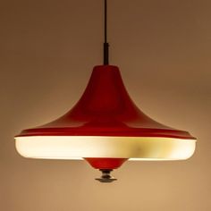 a red light hanging from a ceiling with a white light on it's side