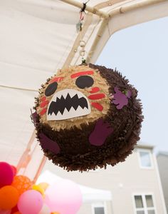 a cake shaped like a monster hanging from a ceiling