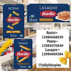 three boxes of pasta sitting on top of a wooden table next to shelves filled with food