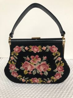 "Mid Century Needlepoint handbag with leather handle and trim. Floral rose design on both sides, bottom and halfway up the sides. Leather handle, brass clasp closure, black lining trimmed with gold on two pockets, additional zippered pocket, and protective brass feet at bottom.  A quality bag. Width is 10\", depth is 2\", height w/o handle is 7.5\" and height w/ handle is 13\" Excellent preowned condition. Clean, No stains or tears." Vintage Needlepoint, Floral Tapestry, Rose Design, Tapestry Design, Leather Trims, Leather Handle, Needlepoint, Purses And Handbags, Satchel