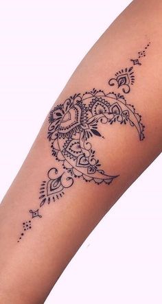 a woman's arm with a tattoo design on it