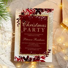 a red and gold christmas party card on top of a table