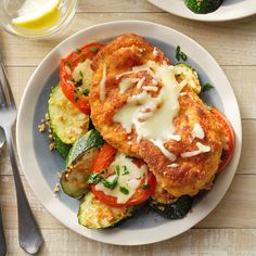 a white plate topped with veggies covered in cheese