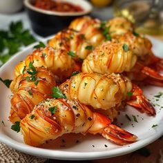 several cooked shrimp on a white plate with parsley garnish and seasoning