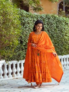 This Set Has a Anarkali, bottom and dupatta. Floral printed tier Anarkali set with hand embroided yoke. It is paired with matching chanderi foil print dupatta enhanced with fabric detailing and palazzo pants. Color: Orange Fabric: Anarkali - Cotton Silk Bottom - Shantoon Dupatta - Chanderi Product Details: Neck Type - Round neck Anarkali Length - 50 inches Bottom Length - 38-40 inches Sleeve Length - 22 inches Note: Available in other colors The product will be delivered within 2-4 weeks of orde Round Neck Anarkali, Fabric Detailing, Silk Anarkali, Silk Bottoms, Orange Fabric, Foil Print, Palazzo Pants, Pants Color, Best Deal