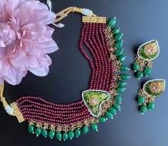 Beautiful Stonework and bright colors are the perfect way to describe this piece. The Set comes with a statement choker along with matching earrings and is perfect for a fun and eccentric look! Grab this piece now for your next event! Red Kundan Jewelry With Peacock Design, Handmade Red Kundan Necklace For Party, Green Bohemian Kundan Necklace For Festive Occasions, Bohemian Green Kundan Necklace For Festive Occasions, Red Meenakari Necklace For Diwali, Red Kundan Necklace Gift For Navratri, Heavy Green Necklaces For Navratri, Green Heavy Necklace For Navratri, Bohemian Green Kundan Necklace For Diwali