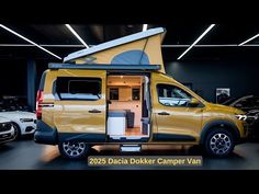 a yellow van parked inside of a garage next to other cars in the parking lot