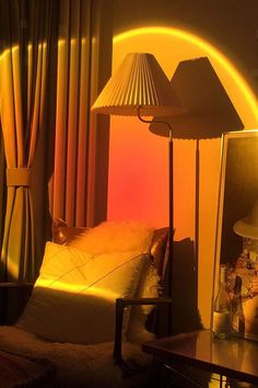 a lamp that is next to a bed in a room with yellow walls and curtains