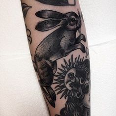 a black and white photo of a rabbit on the arm with sunflowers around it