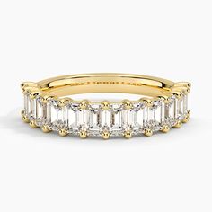 a yellow gold band with baguetts and diamonds