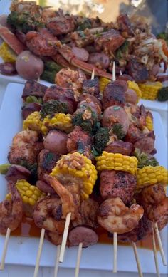 several skewers of food are lined up on a table