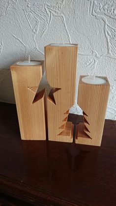 three wooden candles are sitting on a table