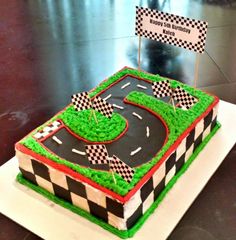 a birthday cake that is shaped like a race track