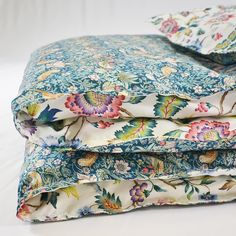 three sheets are stacked on top of each other in different colors and patterns, with one folded up to the side