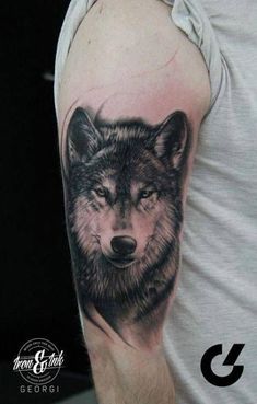 a man with a wolf tattoo on his arm