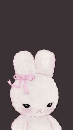 a white stuffed animal with a pink bow on it's head, sitting in front of a black background