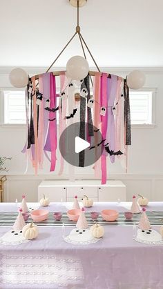 a table topped with lots of pink and white decorations