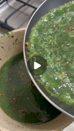 a pot filled with green liquid on top of a stove