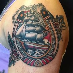 a man with a tattoo on his arm has a ship in the middle of it