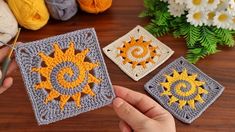 crocheted sun coasters are displayed on a table with yarn and flowers in the background