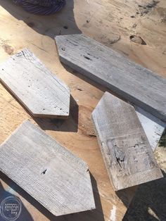 three pieces of wood sitting on top of a wooden table