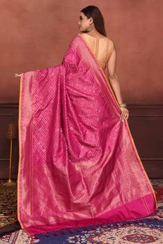 Radiate elegance on festive occasions in this beautiful pink Katan silk Banarasi saree with over all zari work. The saree has yellow edging. It comes with a matching blouse piece. Disclaimer: The shown stitched blouse on the model is for display purpose only. The saree comes with a matching blouse piece and finished with fall and piko. Silk Banarasi Saree, Tussar Silk Sarees, Indian Clothing Store, Latest Designer Sarees, Fashion Journals, Katan Silk, Tussar Silk Saree, Banarasi Saree, Zari Work