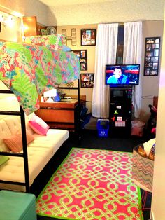 a living room filled with furniture and a flat screen tv on top of a stand