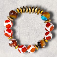 Materials used: Tibetan and fire agate beads and pale and antique gold hematite beads. Length: 7.5" Multicolor Beaded Carnelian Jewelry, Adjustable Carnelian Jewelry With Colorful Beads, Multicolor Carnelian Round Bead Jewelry, Multicolor Agate Jewelry With Faceted Beads, Multicolor Round Carnelian Bead Jewelry, Multicolor Carnelian Bead Jewelry, Artisan Gold Beaded Bracelets With Natural Stones, Handmade Orange Agate Beaded Bracelets, Adjustable Gold Beads, Gems, And Cabochons