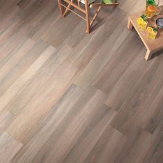 a living room filled with furniture and wooden flooring on top of a hard wood floor