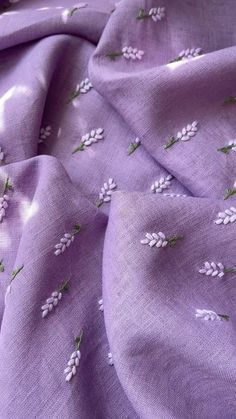 purple fabric with white flowers on it